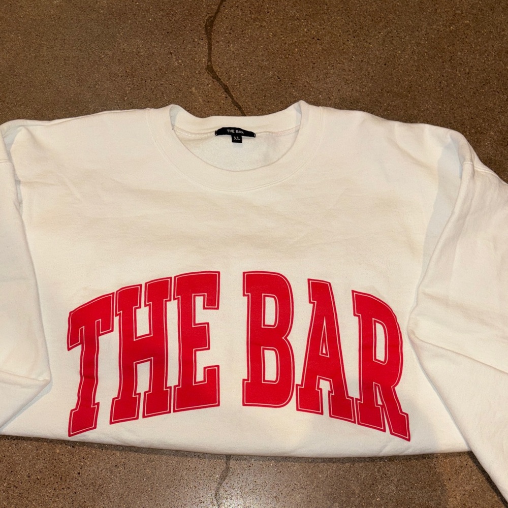 White Sweatshirt with Red 'THE BAR' Print